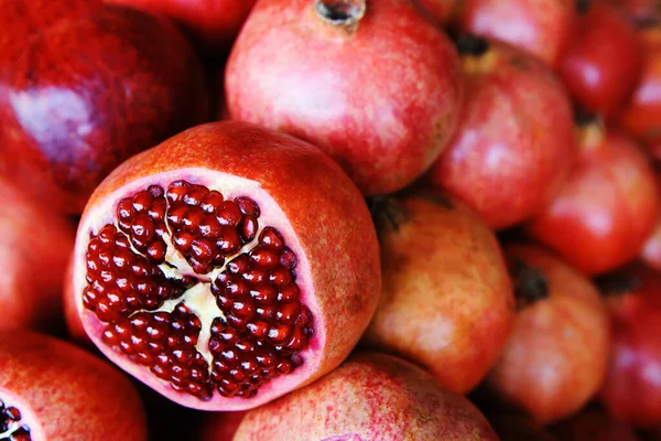Ripe pomegranate fruits on counter in a store