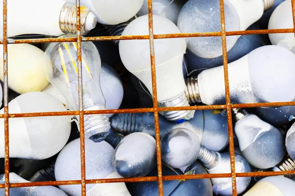 Disposal of light bulbs. Broken lamps in a metal container. Collection and recycling of LED lamps.