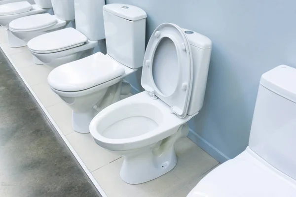 Floor-standing toilets in a plumbing store. Trade in equipment for sanitary rooms