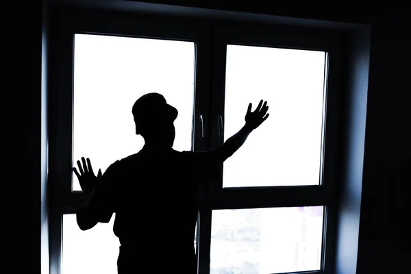 Installation of double-glazed windows. Silhouette of a man on the background of the window. Close-up