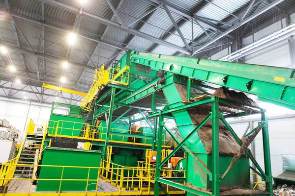 Equipment for sorting household waste in a waste recycling plant. Modern technologies for waste disposal. View of the production hall from the inside