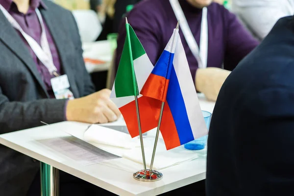 National flags of Russia and Italy. An international delegation during negotiations between the two countries. Cropped frame. No face