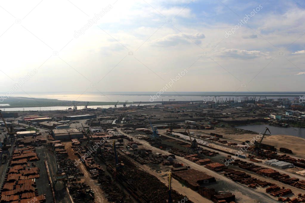 Cargo berths and terminals in the port of Dudinka on the Taimyr Peninsula. Helicopter view of the port Dudinka on the Yenesei river.  Krasnoyarsk region, Russia