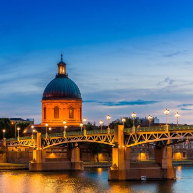 The dome of La Grave and Pont Saint Pierre at night on the Garonne in Toulouse in Haute-Garonne in Occitanie, France clipart