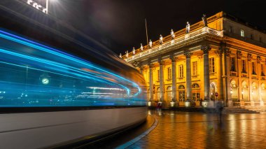 Tram passing the Grand Thtre de Bordeaux at night in New Aquitaine, France clipart