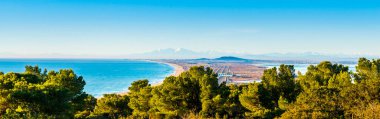 Panorama of the Mediterranean and the Thau lagoon, then in the background the Cap d'Agde and Mount Canigou, from the Mont Saint Clair, with white stones in Sete, Herault in Occitanie, France clipart
