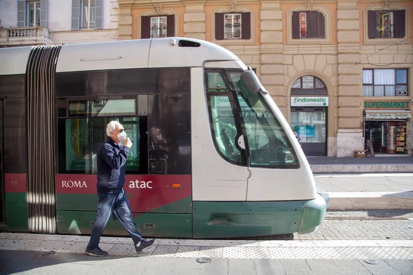 ROMA, İtalya - 01.01.2020 Koruyucu yüz maskeleri takan yaya Roma, İtalya 'da bir tramvaydan indi..