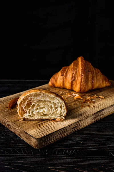 Uma Imagem Vertical Croissant Cortado Meio Inteiro Uma Placa Madeira — Fotografia de Stock