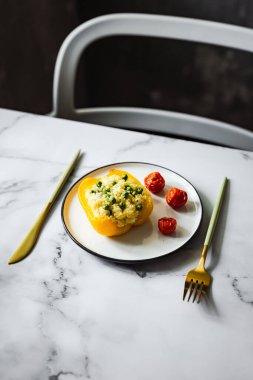 Kuskus, yeşil bezelye, peynir ve vişneli domatesle doldurulmuş fırında sarı biber.