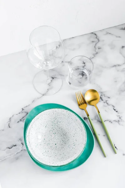 Stylish elegant table setting with ceramic plates on white marble background