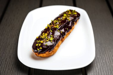 Beyaz tabakta fıstıklı çikolatalı pasta.