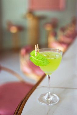 A classic South side cocktail in a nick and nora glass garnished with mint leaf clipart