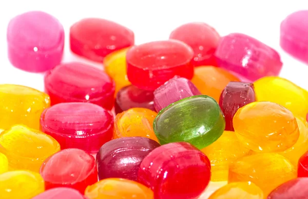 Yellow Red Candies Scattered White Background Them One Green Close — Stock Photo, Image