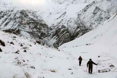 ABC, Nepal - Nisan 2012: Kışın Annapurna kamp yolunda bir köpekle Trekker.