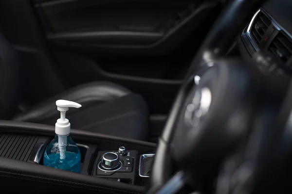 Bottle of blue sanitizer ethyl alcohol hand gel cleanser put in the car, prepare for protecting coronavirus, COVID19