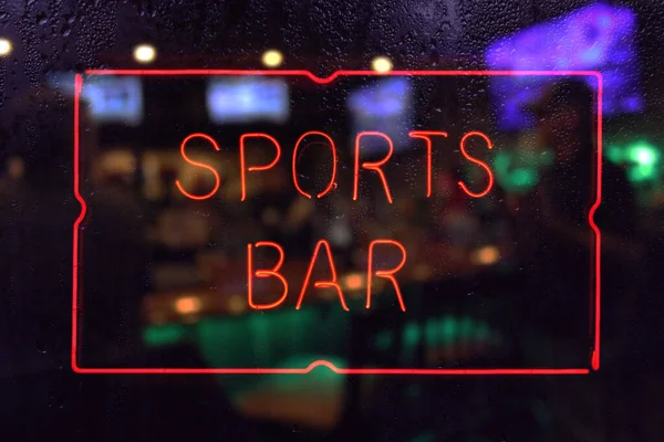 Neon Sports Bar Sign Rainy Window Blur Image — стокове фото