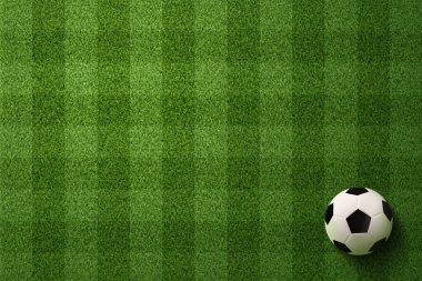 Futbol sahası arka planında futbol topu