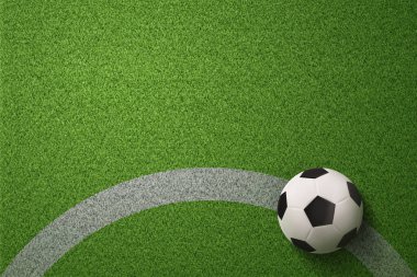 Futbol sahası arka planında futbol topu
