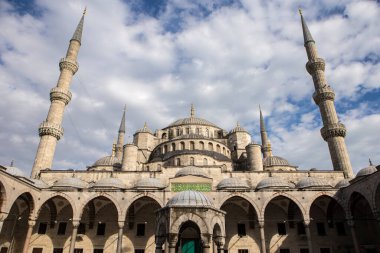 ISTANBUL / TURKEY - 30 / 05 / 2015: Tarihi Sultan Ahmet Camii 'nin (Mavi Cami) güzel bir günü, büyük dairesel kubbesi, eski kemerleri, dört minaresi ve mavi gökyüzünde altın başaklar, beyaz bulutlar
