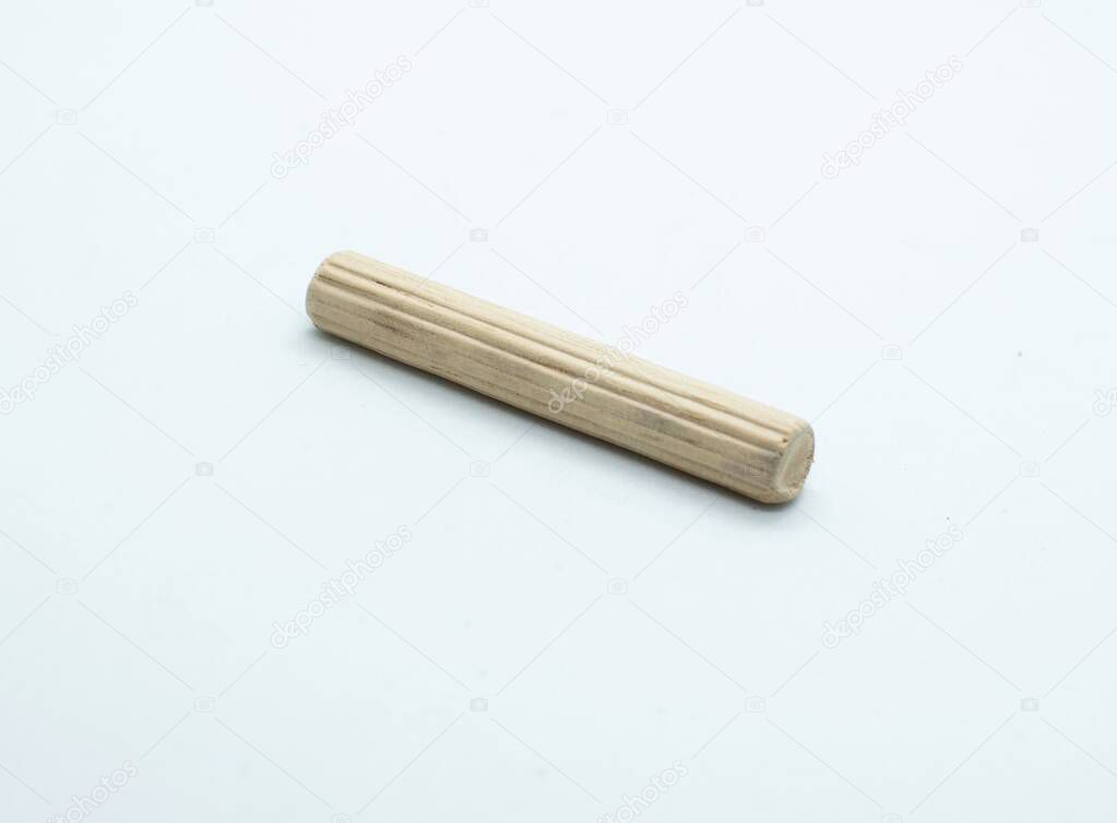 Long size wooden dowel pin isolated on white background.