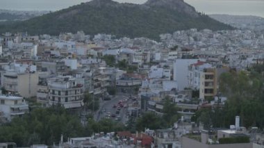 Zaman atlamalı görüntüler Lycabettus Tepesi 'nin yoğun nüfuslu kenar mahallelerinde gün batımında yoğun yollar olduğunu gösteriyor..