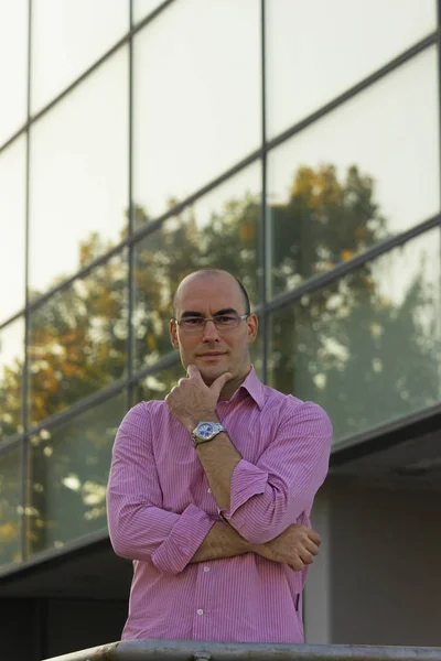 Businessman portrait in front of office building