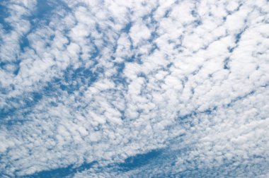 Thin fragrant clouds in the sunny sky clipart