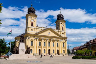Debrecen, Hungary - June 01 2020: The Protestant Great Church - Nagytemplom and the Lajos Kossuth monument with the hungarian flag on the city main square clipart
