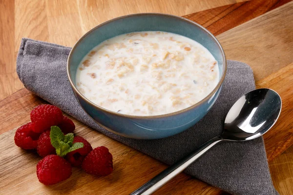 Delicious Bowl Porridge Raspberrys Shot Wooden Board Napkin Cutlery — Stock Photo, Image