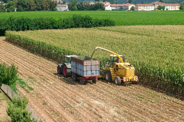 Combine harvester and tractor used in corn harvesting