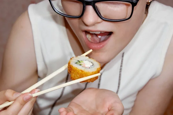 Girl Glasses Piercings Her Tongue Puts Sushi Roll Her Mouth — Stock Photo, Image