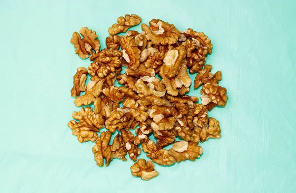 Walnut Kernels Piled Close Turquoise Background View Top — Stock Photo, Image