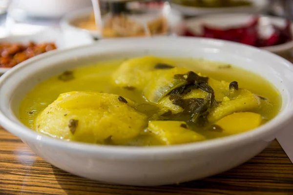 Traditional hot yellow Kubbe soup, a famous middle eastern dumplings soup dish, served in a bowl. Jerusalem, Israel. — Stock Image Traditional Hot Yellow Kubbe Soup Famous Middle Eastern Dumplings Soup Stock Photo