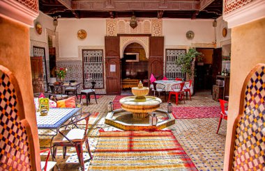 Interior of a Riad (small family owned hotel) in the Medina of Marrakesh.View of the riad's central courtyard,with traditional mosaics and decorations. clipart