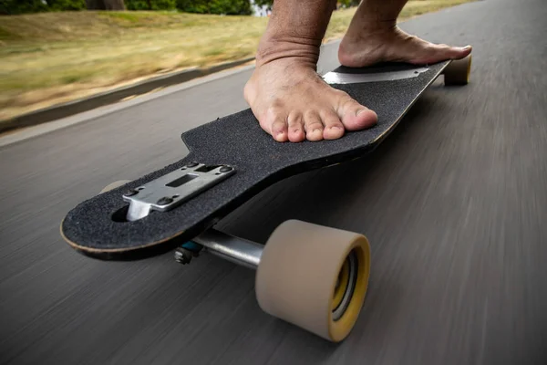 close up on barefoot man riding a  skateboarding