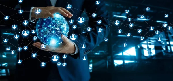 Businessman holding global customer network connection in hands.Technology and network structure and data exchanges communication on dark blue background. Elements of this image furnished by NASA