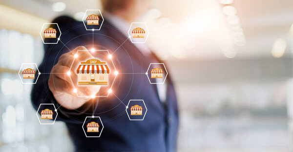 Businessman hand touching icon global network connection on franchise marketing system.