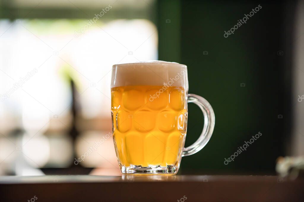 mug full of chopp, with chopp pilsen on a rustic table