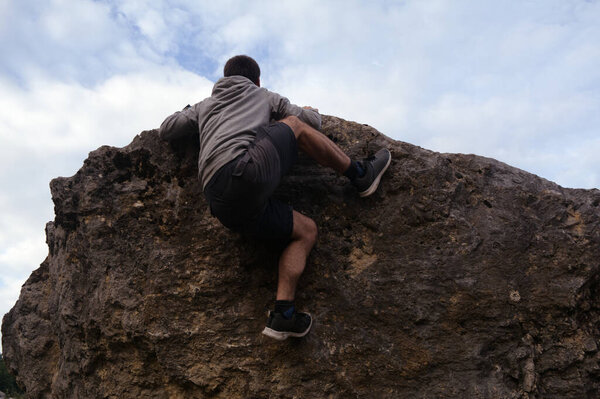 young man climbing in the mountains