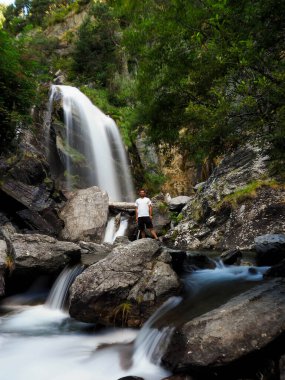 Dağlarda şelalesi olan genç bir adam