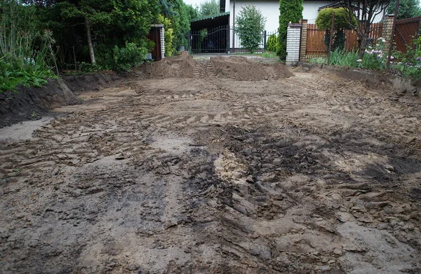 sand with traces of tires in the yard during construction