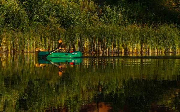 ラトビアのリガ2020年7月17日 日の出時に市川 ゴムボートに乗る漁師 — ストック写真