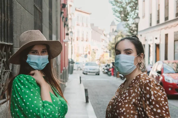 Two girls friends wearing mask in the new normal