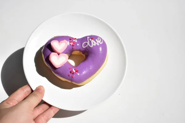 Tasty and beautiful violet doughnut, donut isolated, white background, top view, junk food, sugary, sweet, homemade, close up