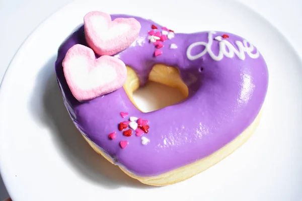 Tasty and beautiful violet doughnut, donut isolated, white background, top view, junk food, sugary, sweet, homemade, close up