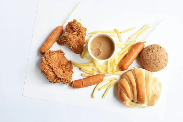 Tasty, delicious breakfast table, dish of sweet croissant, friend chicken, Korean sesame Mochi bread or Japanese Mochi bun, pig sausage, milk coffee paper cup, white background, junk food, fast food