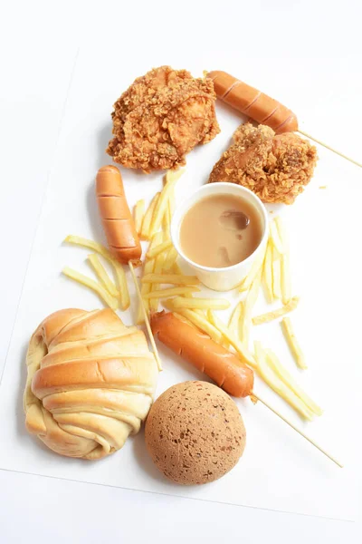Tasty, delicious breakfast table, dish of sweet croissant, friend chicken, Korean sesame Mochi bread or Japanese Mochi bun, pig sausage, milk coffee paper cup, white background, junk food, fast food