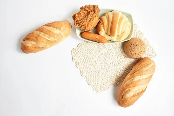 Beautiful, delicious breakfast table, dish of sweet croissant, Korean sesame Mochi bread or Japanese Mochi bun, Vietnamese bread (Banh mi), pig sausage white background, bakery, loaf, junk food