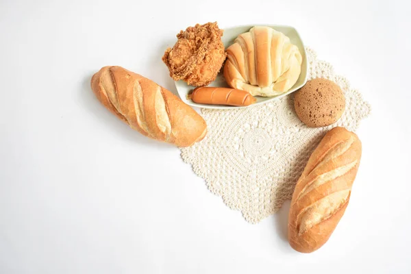 Beautiful, delicious breakfast table, dish of sweet croissant, Korean sesame Mochi bread or Japanese Mochi bun, Vietnamese bread (Banh mi), pig sausage white background, bakery, loaf, junk food