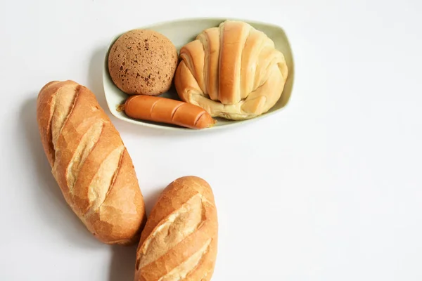 Beautiful, delicious breakfast table, dish of sweet croissant, Korean sesame Mochi bread or Japanese Mochi bun, pig sausage white background, bakery, junk food, fast food